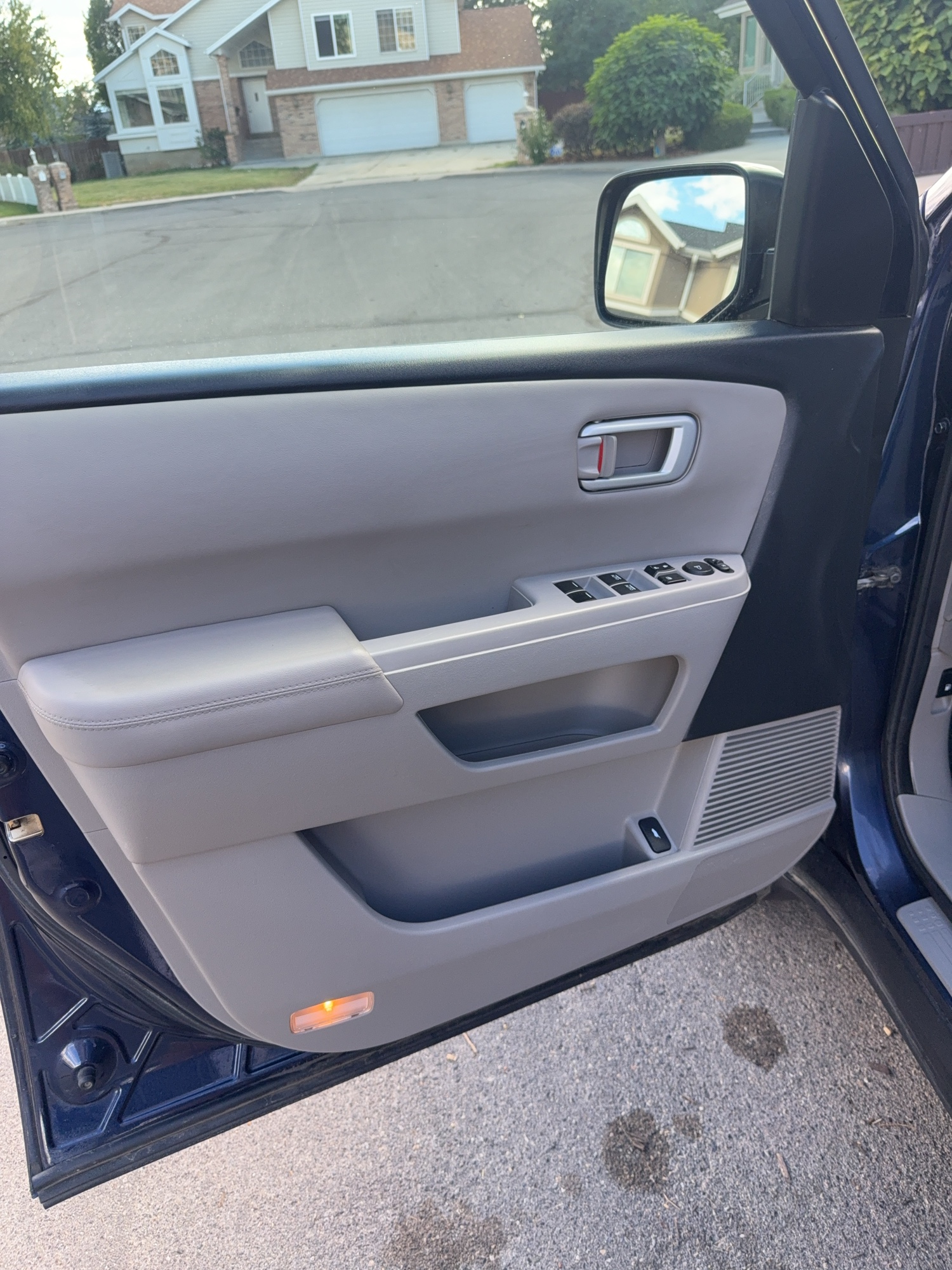 Interior door panel and window switch controls before and after detailing — after