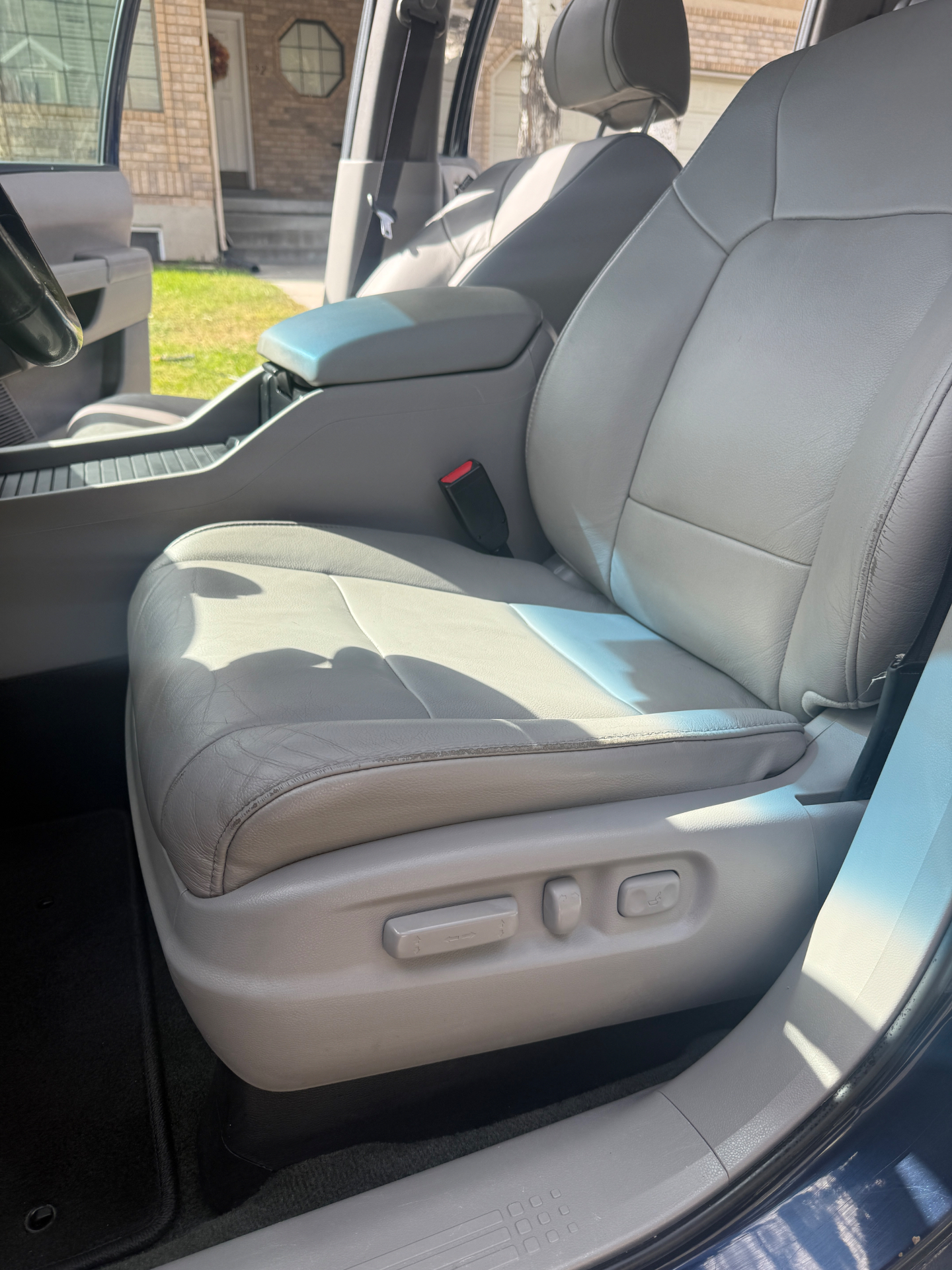 Car leather driver seat before and after deep cleaning and conditioning — before
